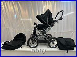 4 wheel push chair with free carry cot, rain cover and baby bag in black