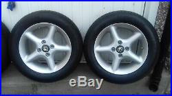 Four alloy wheels with new tyres 14 inch originally from a mazda